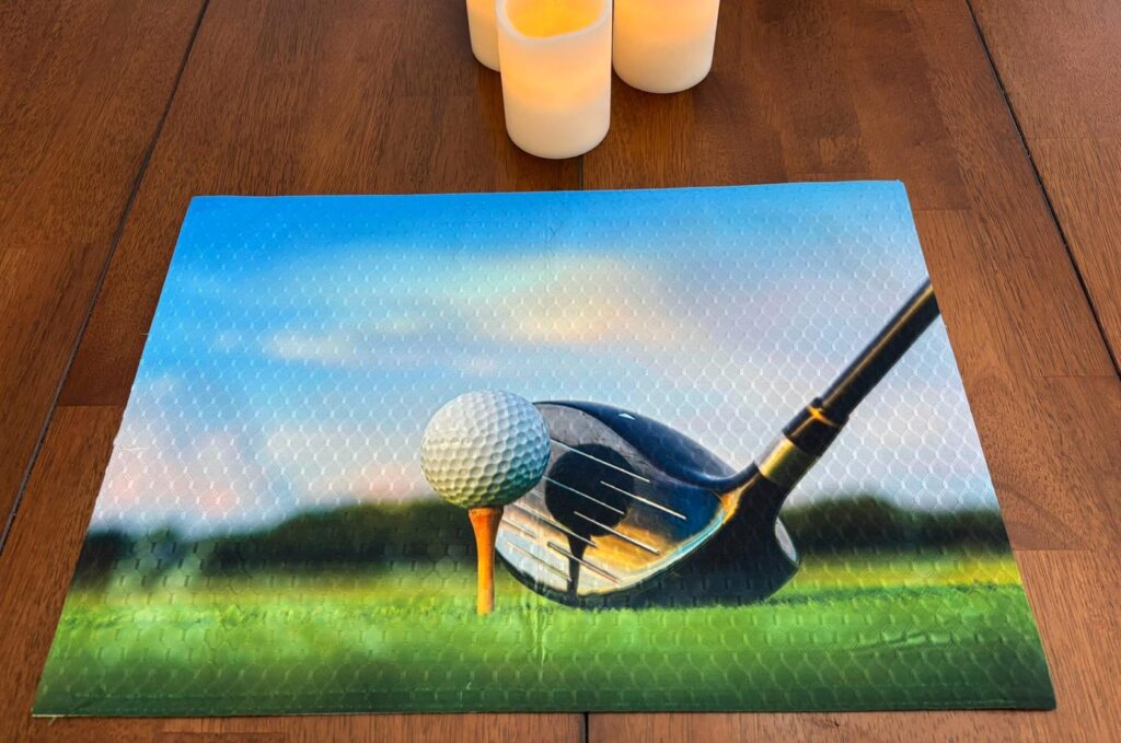 Golf Driver Right Side Teed Up Golf Ball Reflecting in Driver Face
